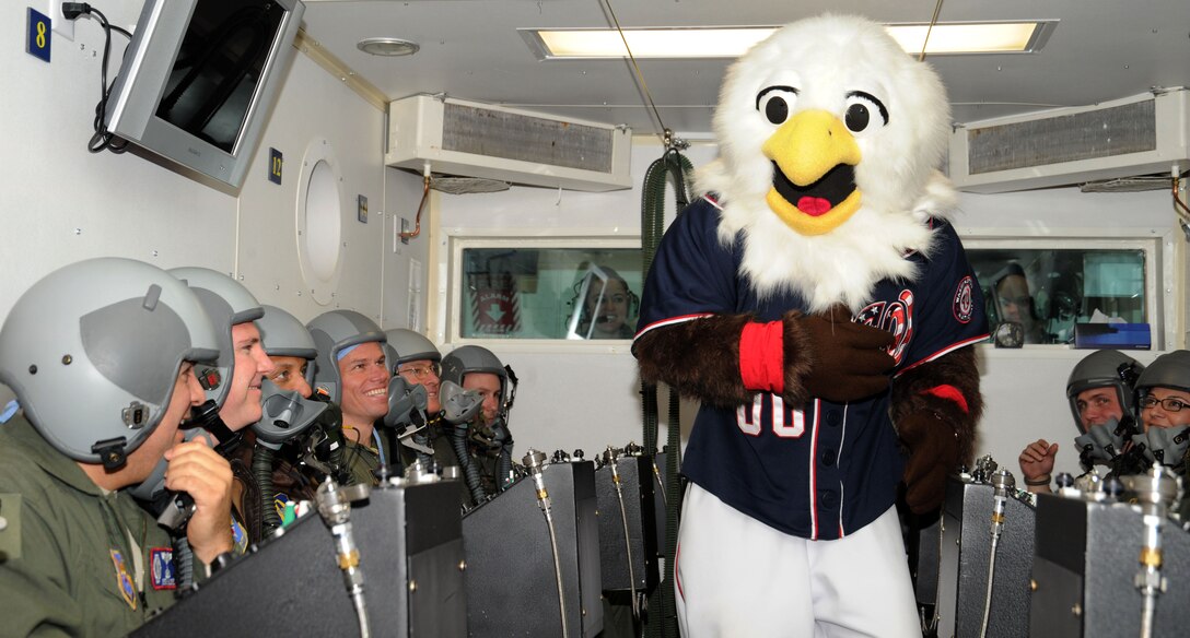 The Washington Nationals mascot, "Screech," visits team Andrews members at high altitude chamber training in Aero Space Physiology during a base tour here April 24. The purpose of the visit was to see and learn about the missions on Joint Base Andrews. During the visit Screech and his video team collected footage for Joint Service Open House promotional videos being shown at Andrews Night at the Washington Nationals May 16. (U.S. Air Force photo/ Airman 1st Class Aaron Stout)