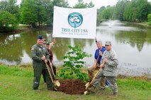 (From left) U.S. Air Force Col. Don Godier, 20th Fighter Wing vice commander, Lt. Col. Matthew Benivegna, 20th Civil Engineer Squadron commander, Doug Back, 20th CES base forester, and Jimmy Walters, South Carolina Forestry Commission Urban Forester, plant a red bud tree at Memorial Lake at Shaw Air Force Base, S.C., April 20, 2012. The tree was planted in honor of Arbor Day and Shaw being recognized as a Tree City for 2011. (U.S. Air Force photo by Airman 1st Class Hunter Brady/Released)