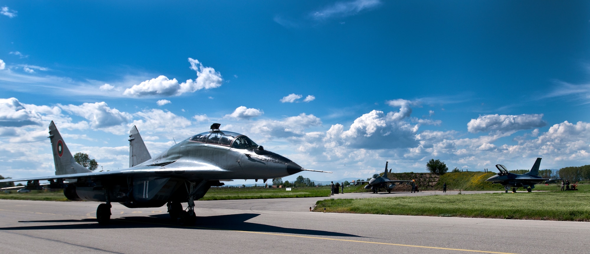 A Bulgarian air force MiG-29 pilot taxis past two U.S. Air Force F-16 Fighting Falcons April 19, 2012, at Graf Ignatievo Air Force Base, Bulgaria. Two fighter squadrons and more than 500 personnel are deployed here from the 31st Fighter Wing, Aviano Air Base, Italy, in support of Thracian Star 2012, an exercise geared toward strengthening partnerships and increasing the interoperability between NATO allies. (U.S. Air Force photo/Senior Airman Katherine Windish)