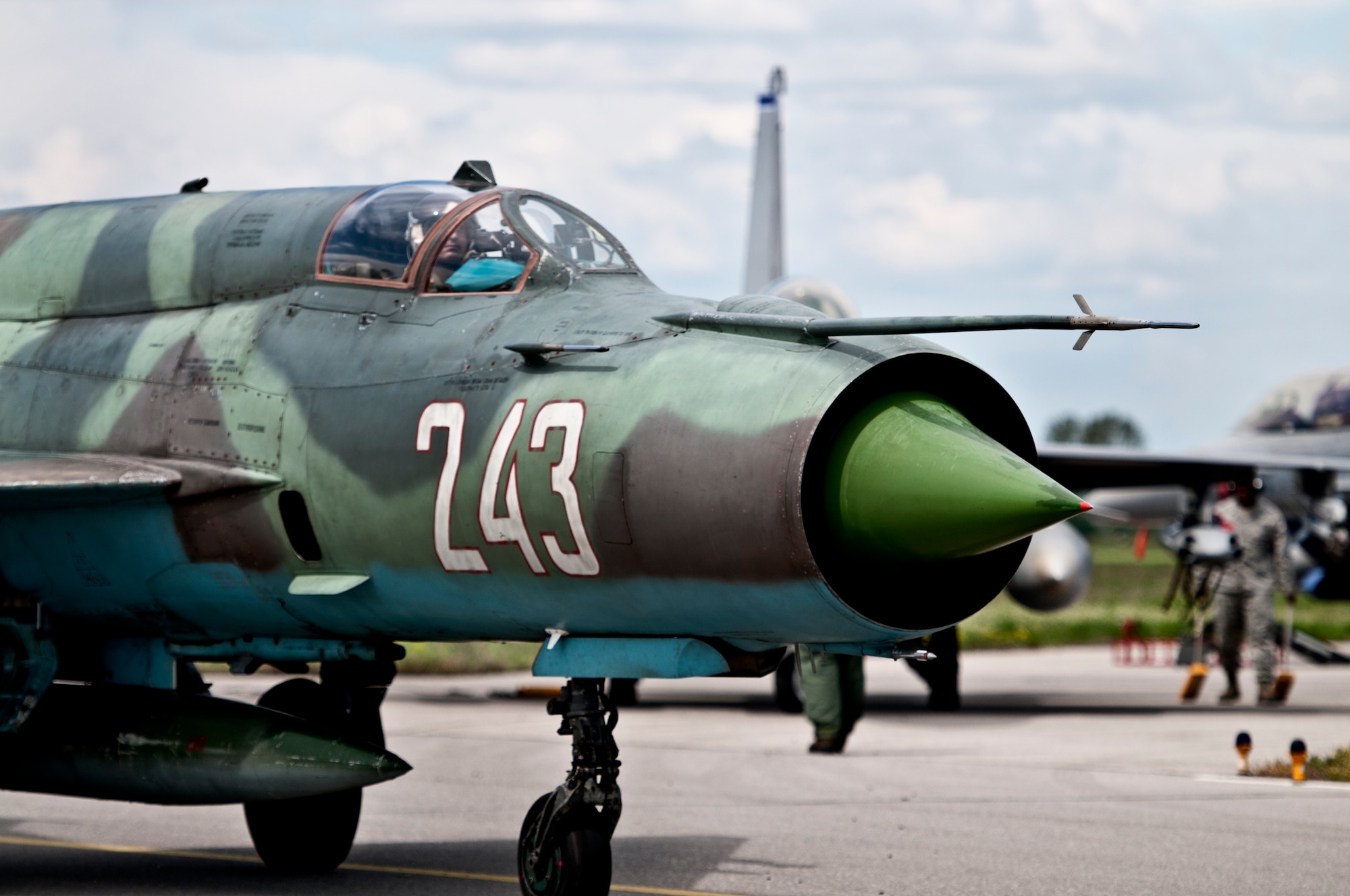 A Bulgarian air force MiG-21 pilot taxis past U.S. Air Force F-16 Fighting Falcons April 19, 2012, at Graf Ignatievo Air Force Base, Bulgaria. Two U.S. fighter squadrons and more than 500 personnel are deployed here from the 31st Fighter Wing, Aviano Air Base, Italy, in support of Thracian Star 2012.  The month-long exercise is geared toward strengthening partnerships and increasing interoperability between NATO allies. (U.S. Air Force photo/Senior Airman Katherine Windish)