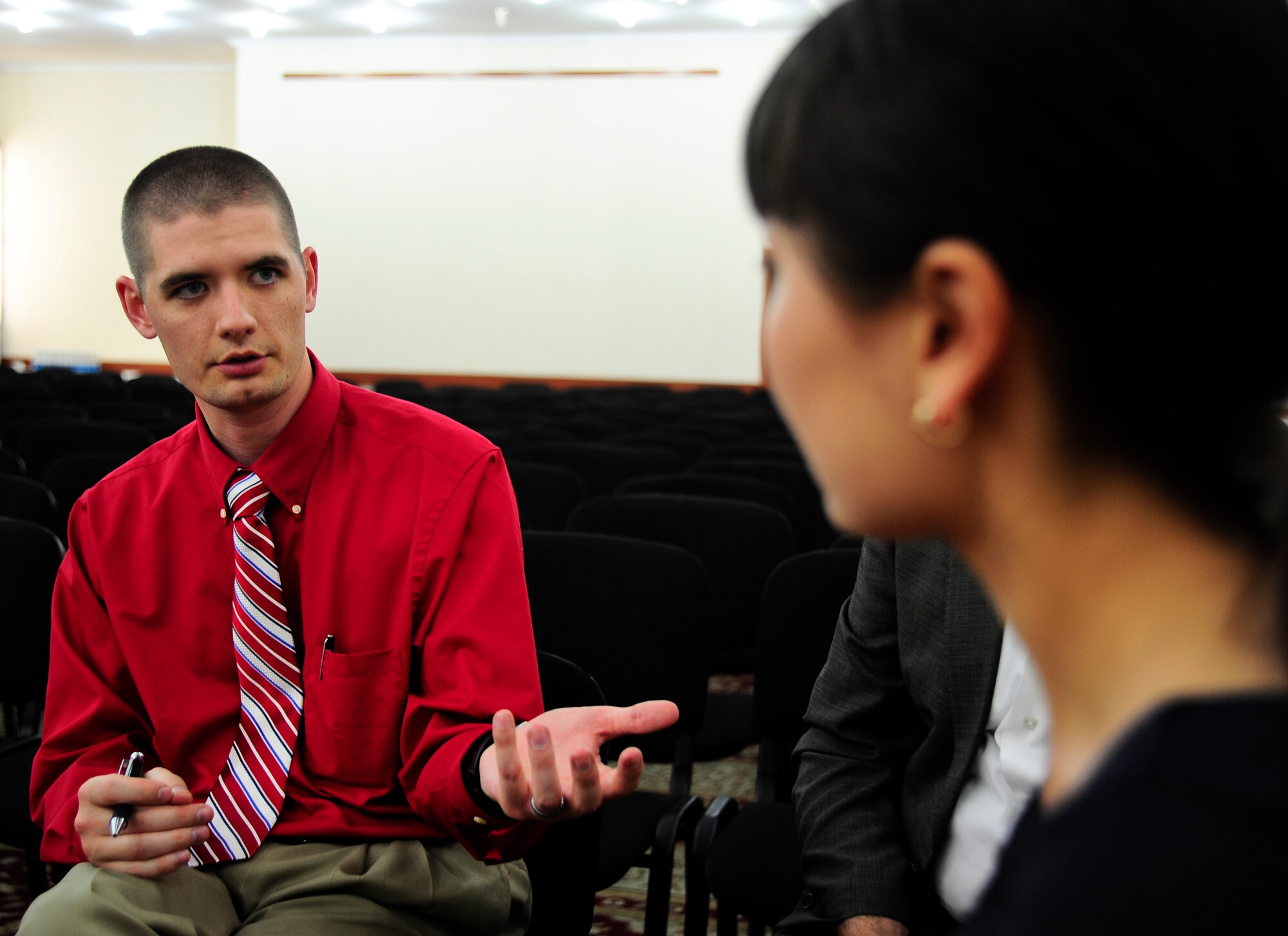 Staff Sgt. Francis Dunn talks to a Kyrgyz Republic businesswoman April 24, 2012, during the Kyrgyzstan Industry Training Symposium in Bishkek, Kyrgyzstan. Airmen from the Transit Center at Manas, Kyrgyzstan, participated in the symposium to do business with contractors in the Kyrgyz Republic. Dunn is a 376th Expeditionary Contracting Squadron commodities flight chief deployed to the Transit Center from Little Rock Air Force Base, Ark. (U.S. Air Force photo/Staff Sgt. Angela Ruiz)