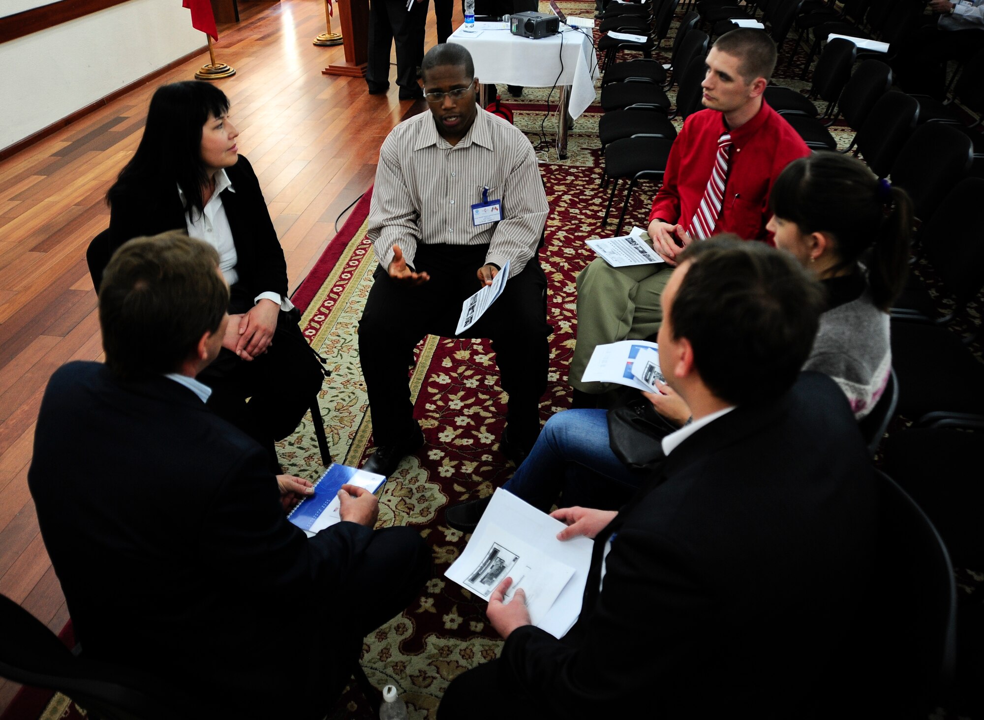Senior Airman Wayne Green and Staff Sgt. Francis Dunn conduct group sessions with Kyrgyz Republic businessmen and women April 24, 2012, during the Kyrgyzstan Industry Training Symposium in Bishkek, Kyrgyzstan. Green and Dunn are deployed to the Transit Center at Manas, Kyrgyzstan. Green is a 376th Expeditionary Contracting Squadron construction flight chief deployed from Maxwell Air Force Base, Ala. Dunn is a 376th ECONS commodities flight chief deployed from Little Rock AFB, Ark. (U.S. Air Force photo/Staff Sgt. Angela Ruiz)