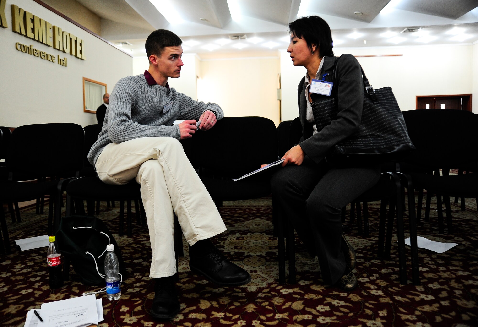 Senior Airman Bryce Pagel conducts a one-on-one session with Gulnaz Baiturova April 24, 2012, during the Kyrgyzstan Industry Training Symposium in Bishkek, Kyrgyzstan. The one-on-one sessions allowed companies that had particular questions to be able to sit down and discuss them with a U.S. government representative. Pagel is a 376th Expeditionary Contracting Squadron services contracting officer deployed to the Transit Center at Manas, Kyrgyzstan, from Grand Forks Air Force Base, N.D. (U.S. Air Force photo/Staff Sgt. Angela Ruiz)