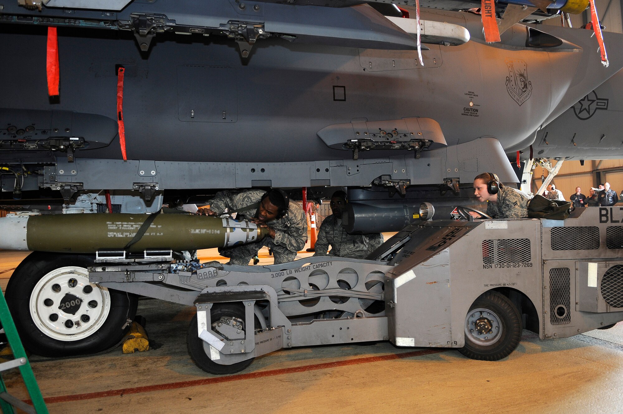 ROYAL AIR FORCE LAKENHEATH, England -- Staff Sgt. Arthur Belvin (left), and Airman 1st Class Ashton Colburn (right), 494th Aircraft Maintenance Unit weapons load crew members prepare to load a Guided Bomb Unit-38 munition onto an F-15E Strike Eagle during the quarterly Load Crew Competition April 20, 2012. The competition features the best load crew teams from the 492nd, 493rd and 494th AMUs. The winner is determined by the fastest time loading munitions with the least amount of errors.  (U.S. Air Force photo by Staff Sgt. Connor Estes)