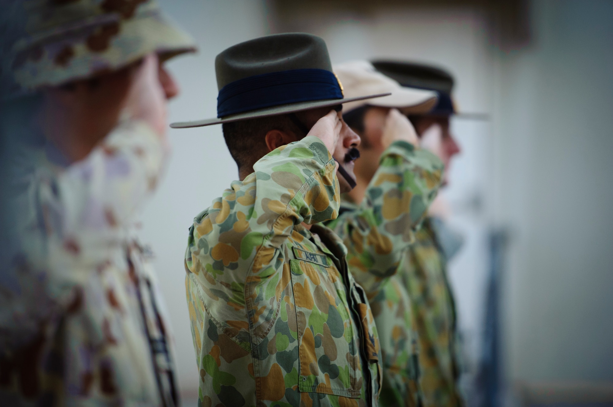SOUTHWEST ASIA – Australian service members salute during the playing of the Australia and New Zealand national anthems during an Australian and New Zealand Army Corps Day ceremony here April 25, 2012. ANZAC Day commemorates those who fought and died during the Gallipoli Campaign in the Ottoman Empire during World War I and also remembers all service members who have fought and died during conflicts throughout each country’s history. (U.S. Air Force photo/Staff Sgt. Nathanael Callon)