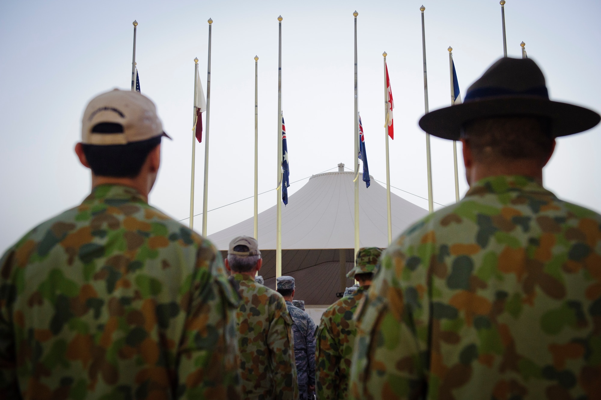 SOUTHWEST ASIA – Service members from the U.S., Australia, United Kingdom, Canada, and France stand for a moment of silence in honor of the fallen during an Australian and New Zealand Army Corps Day ceremony here April 25, 2012. ANZAC Day commemorates those who fought and died during the Gallipoli Campaign in the Ottoman Empire during World War I and also remembers all service members who have fought and died during conflicts throughout each country’s history.  (U.S. Air Force photo/Staff Sgt. Nathanael Callon)