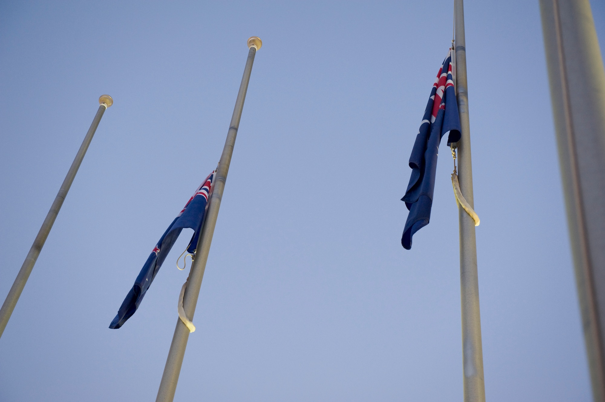 SOUTHWEST ASIA – The Australia and New Zealand flags are lowered to half-staff during an Australian and New Zealand Army Corps Day ceremony here April 25, 2012. The ceremony was held at early dawn to reflect on the peaceful moments the soldiers had before dawn, when the fighting would continue during the Gallipoli campaign. (U.S. Air Force photo/Staff Sgt. Nathanael Callon)