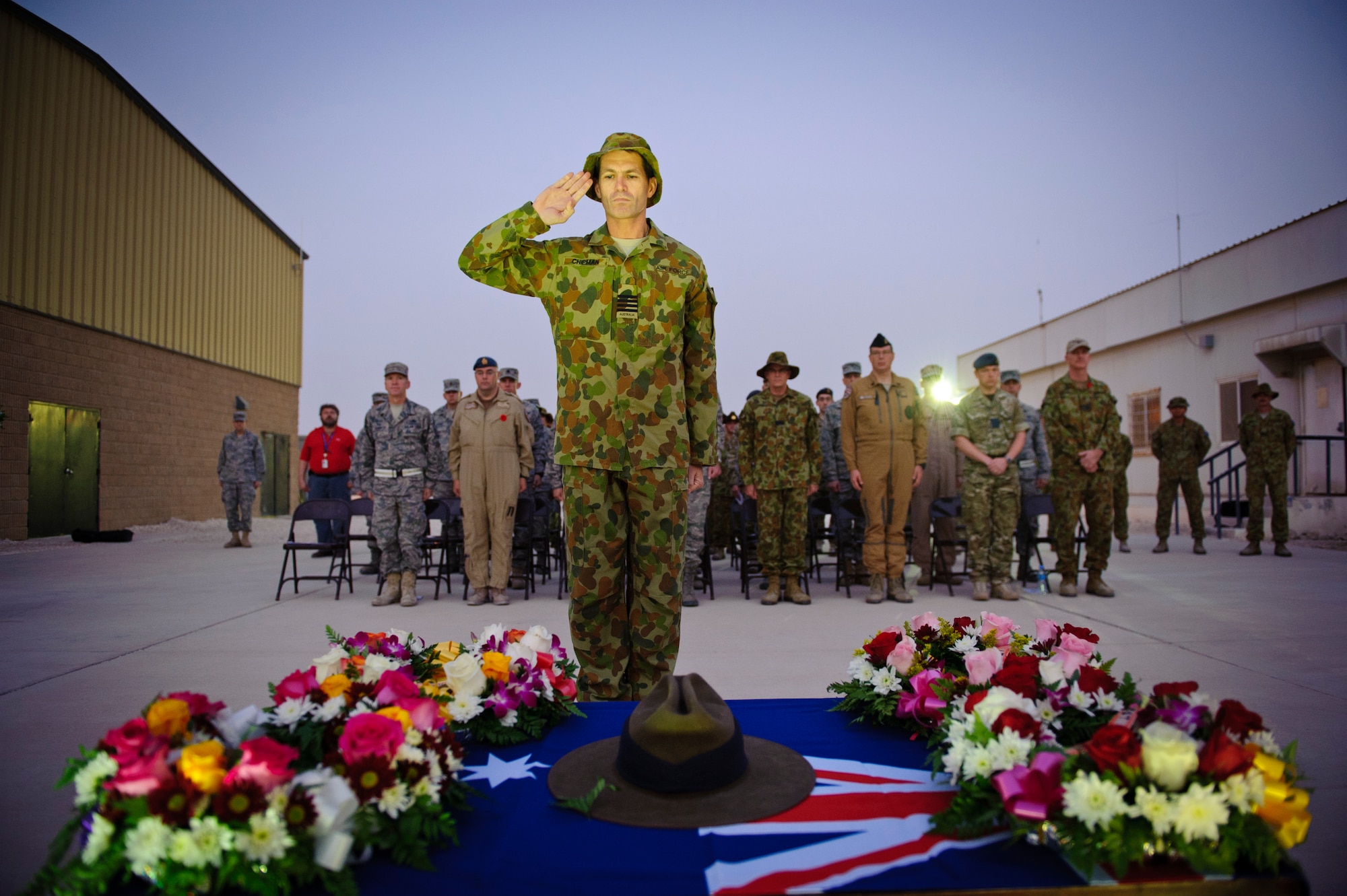 SOUTHWEST ASIA – Royal Australian Air Force Group Capt. Robert Chipman salutes after laying a wreath in honor of fallen service members during an Australian and New Zealand Army Corps Day ceremony here April 25, 2012. ANZAC Day, similar to U.S. Memorial Day, honors and remembers the sacrifices of service members from Australia and New Zealand. (U.S. Air Force photo/Staff Sgt. Nathanael Callon)