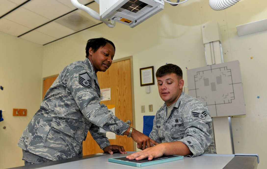 ANDERSEN AIR FORCE BASE, Guam—Master Sgt. Devin Wilson, 36th Medical Group, explains the diagnostic imaging process to Senior Airman Ben Nelson, 736th Security Forces Squadron, at the 36 MDG clinic April 18. The clinic can support outpatient process for military members and their dependants. (U.S. Air Force photo by Senior Airman Benjamin Wiseman/Released)
