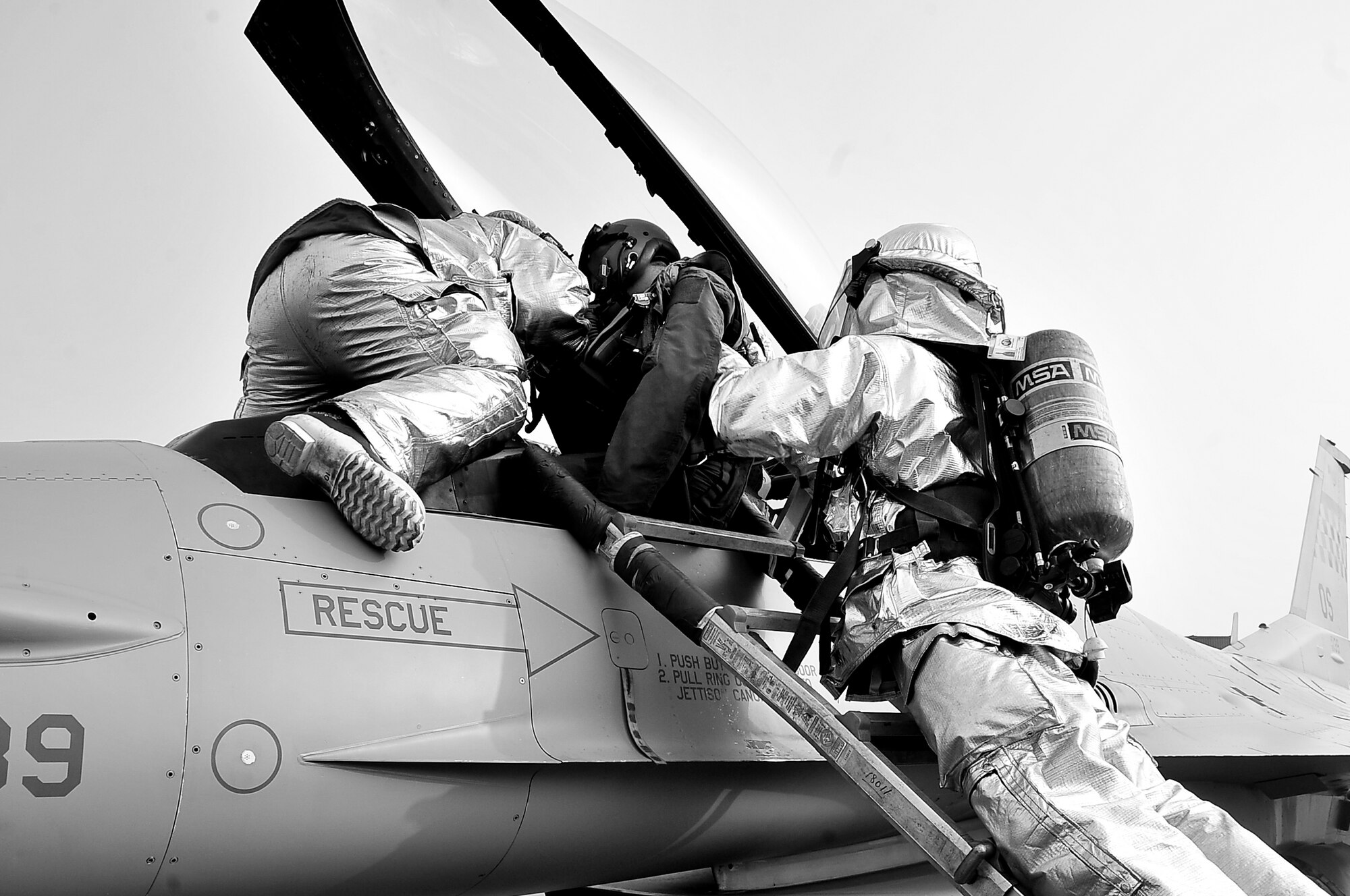 Firefighters from the 51st Civil Engineer Squadron extract 1st Lt. Richard Greer III, 36th Fighter Squadron pilot, during the Operational Readiness Exercise portion of the Consolidated Unit Inspection here, April 23, 2012. The CUI aligns inspections during different leadership cycles to check for operational readiness and unit compliance. (U.S. Air Force photo/Senior Airman Adam Grant)         