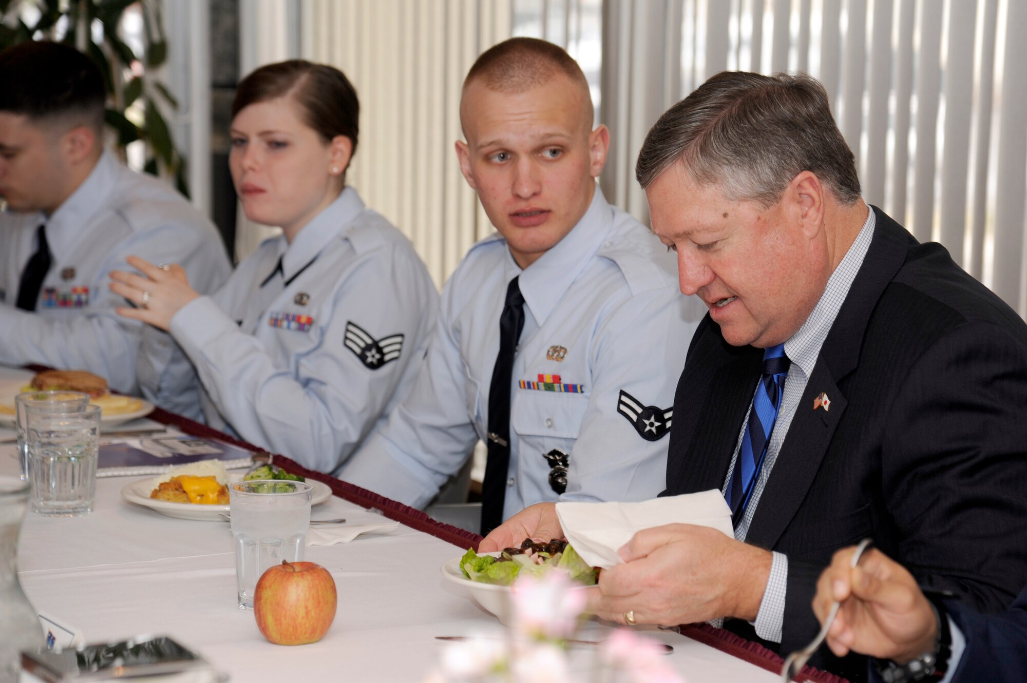 Secretary of the Air Force Michael Donley talks with Airmen during lunch at the Grissom Dining Facility at Misawa Air Base, Japan, April 23, 2012. Approximately 11 Airmen shared a meal with the secretary and asked questions regarding funding and the future of the Air Force. During his visit to Misawa, Donley met with Airmen and toured various base facilities. (U.S. Air Force photo/Tech. Sgt. Marie Brown/Released)

