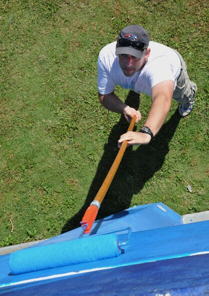 HAGATNA, Guam—Lt. Col. Michael Staples, 36th Civil Engineer Squadron commander, paints a wall of the M.U. Lajan Elementary School April 21. Members from the 36 CES volunteered during their Saturday to make renovations to the elementary school. (U.S. Air Force photo by Senior Airman Benjamin Wiseman/Released)