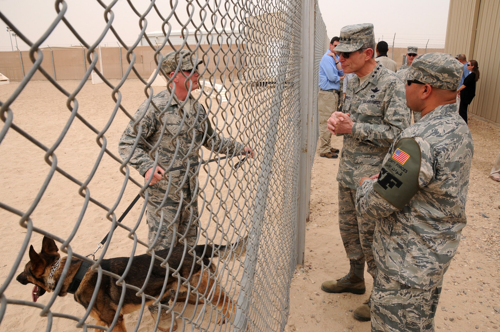Air Force Chief of Staff Gen. Norton Schwartz views a military working dog in training alongside Tech. Sgt. Adolph Rodriguez, 386th Expeditionary Security Forces Squadron Military Working Dog kennel master, April 21, 2012, at an undisclosed location in Southwest Asia. Schwartz was visiting to meet and speak with deployed members attached to the 386th Air Expeditionary Wing. (U.S. Air Force photo/Staff Sgt. James Lieth)