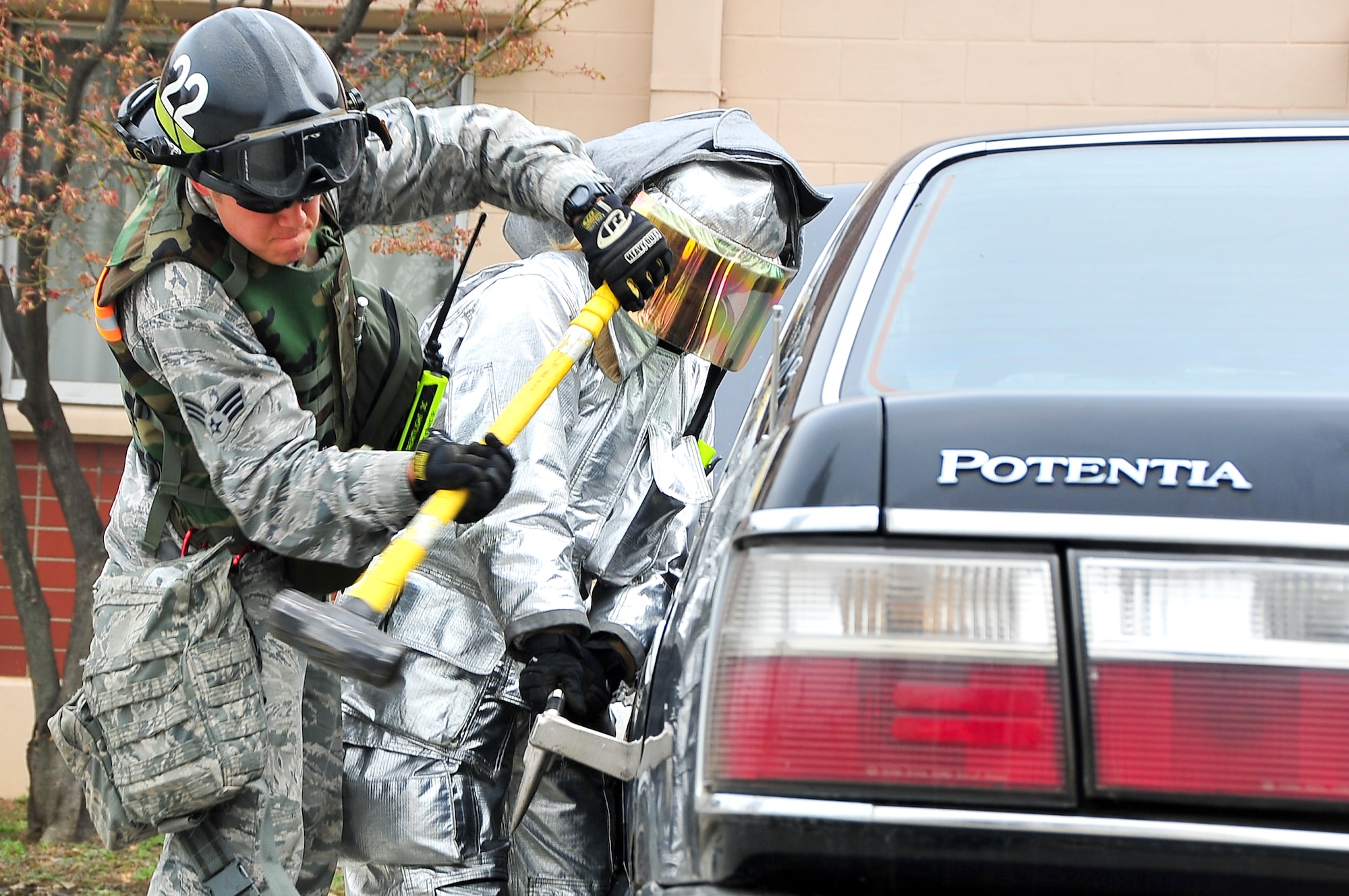 Senior Airman Brian Whitener, 51st Civil Engineer Squadron firefighter, breaks the lock off a vehicle during the Operational Readiness Exercise portion of the Consolidated Unit Inspection here, April 23, 2012. The CUI aligns inspections during different leadership cycles to check for operational readiness and unit compliance. (U.S. Air Force photo/Senior Airman Adam Grant)             