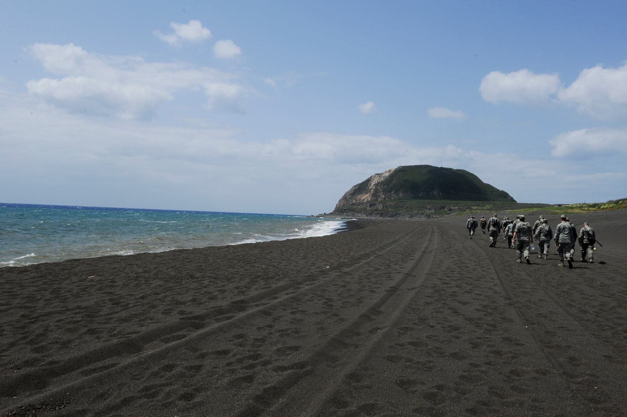 Airmen from Kadena's 18th Operation Group walk down the beach of Iwo To, formally known as Iwo Jima, Japan, before hiking up to the top of Mount Suribachi during a tour March 30, 2012. Mount Suribachi is site where the infamous photograph of five Marines and a Navy corpsman raising the American flag was taken. (U.S. Air Force photo by Airman 1st Class Brooke P. Beers/Released)