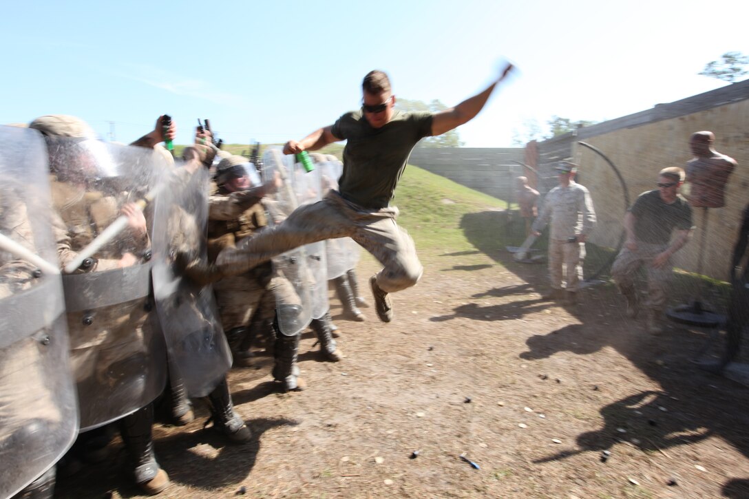 U.S. Marines from the ground combat element for Security Cooperation Task Africa Partnership Station 12 (APS-12), conduct scenario based riot control exercises against their fellow U.S. Marines aboard Stone Bay, N.C., April 26, 2012. This training is part of APS-12's special operations capabilities certification in support of their upcoming deployment to Africa.