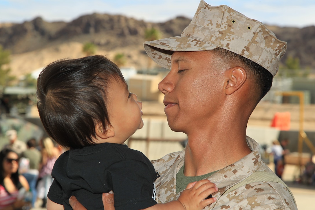 Staff Sgt. Reynaldo Holtman, light armored vehicle commander, 3rd Light Armored Reconnaissance Battalion, plays with his 1-year-old son Junior at the unit's Motor-T ramp before the battalion left for a deployment to Afghanistan April 26, 2012. (Official USMC photo by Sgt. Heather Golden / Released)