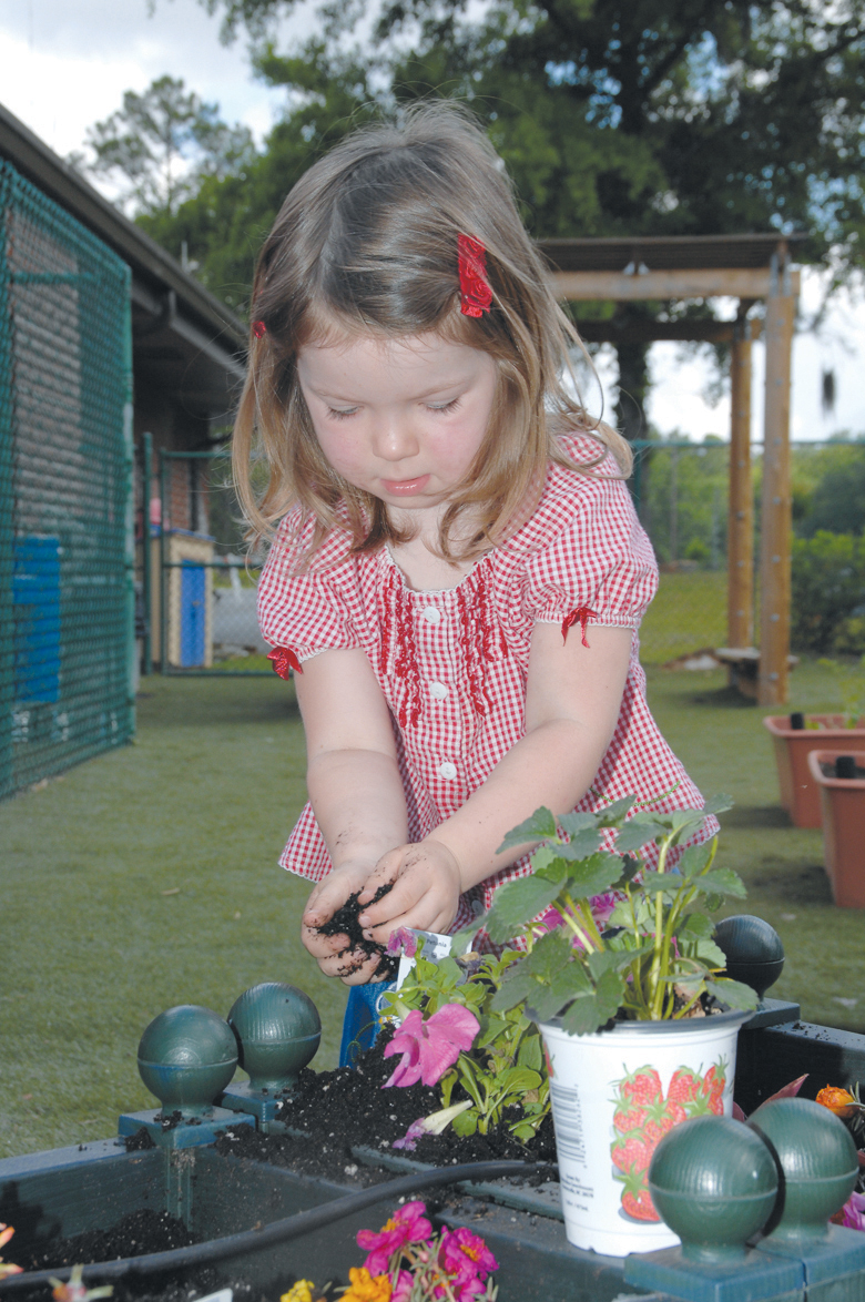 Rylie Childers, 4, is one of many children at the Child Development Center, Marine Corps Logistics Base Albany, who planted flowers and vegetables in recognition of Earth Day, April 20. "I planted pink flowers," she said. "I dug up the dirt, put the flowers in it and put dirt on top of it. I never planted flowers before."
