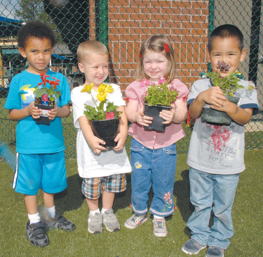 Children at the Child Development Center, Marine Corps Logistics Base Albany, plant flowers and vegetables in recognition of Earth Day, April 20.