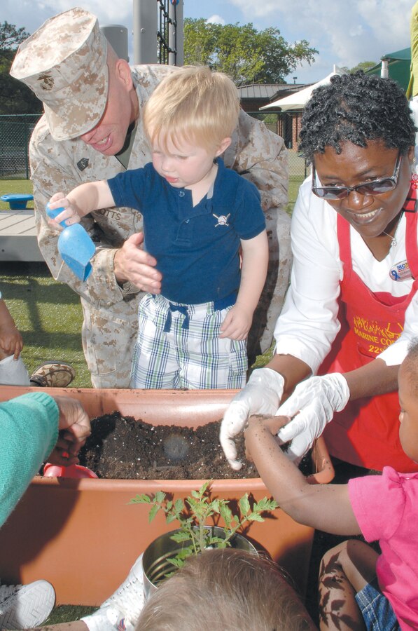 Children at the Child Development Center, Marine Corps Logistics Base Albany, plant flowers and vegetables in recognition of Earth Day, April 20.