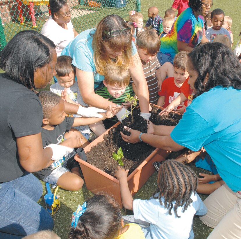 Children at the Child Development Center, Marine Corps Logistics Base Albany, plant flowers and vegetables in recognition of Earth Day, April 20.