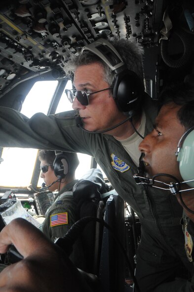Master Sgt. Mark Crane, flight engineer, Kentucky Air National Guard, and Bangladesh Air Force Sgt. Mohammad Moniruzzaman, flight engineer,  monitor aircraft conditions during a flight in support of exercise Cope South at Kurmitola Air Base, Bangladesh, on April 25, 2012. C-130 flight engineers monitor aircraft engine systems, determine the performance of the aircraft and manage checklists during each flight. Exercise Cope South 12 is a bilateral tactical airlift exercise conducted between the two air forces scheduled through April 26, 2012.    (U.S. Air Force photo/1st Lt Cammie Quinn)