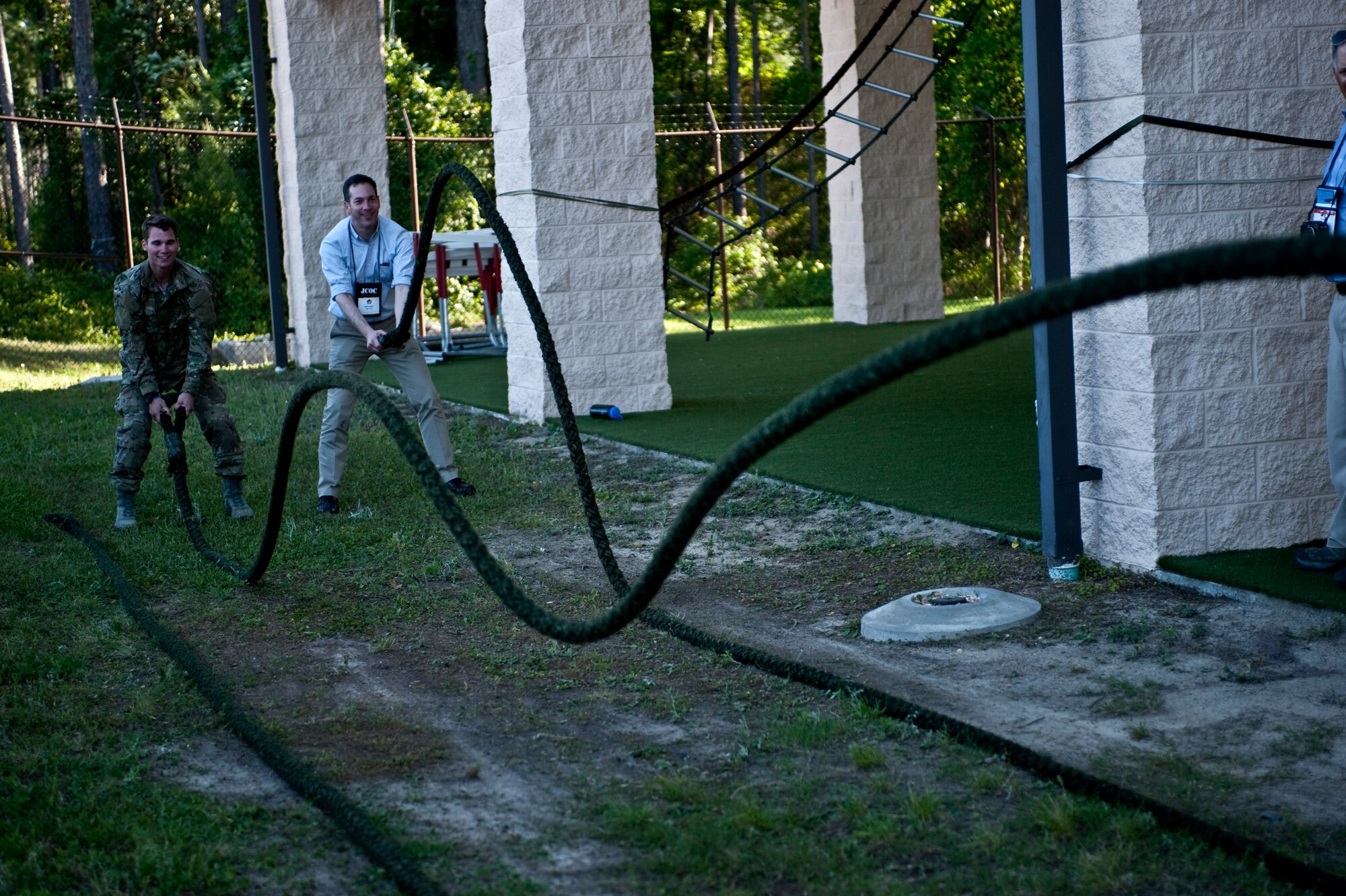 A Joint Civilian Orientation Conference attendee and Special Tactics Training Squadron student demonstrate exercises at the Special Tactics Training Squadron on Hurlburt Field, Fla., April 24, 2012. The JCOC attendees were shown some of the physical training equipment STTS students use. (U.S. Air Force Photo/Airman 1st Class Hayden K. Hyatt)