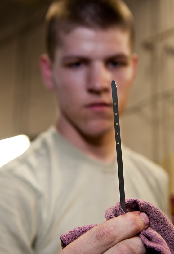 Airman 1st Class Dillion Rickman, 28th Logistics Readiness Squadron vehicle and vehicular equipment mechanic, checks oil levels in a government vehicle during routine maintenance in the vehicle maintenance shop at Ellsworth Air Force Base, S.D., April 24, 2012. The dipstick allows the mechanics to verify the amount of oil already pumped into the vehicle, ensuring proper engine operation. (U.S. Air Force photo by Airman 1st Class Kate Thornton/Released)