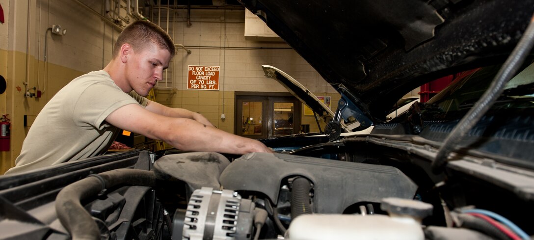 Airman 1st Class Dillion Rickman, 28th Logistics Readiness Squadron vehicle and vehicular equipment mechanic, changes oil in a government vehicle during routine maintenance in the vehicle maintenance shop at Ellsworth Air Force Base, S.D., April 24, 2012. Vehicle maintenance is responsible for regular  up keep of Ellsworth’s entire government vehicle fleet, including routine work and preventative maintenance. (U.S. Air Force photo by Airman 1st Class Kate Thornton/Released)