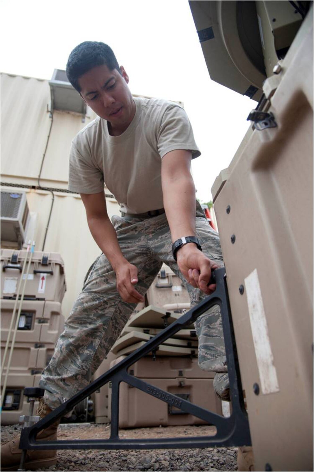 Tactical Networking technician Senior Airman Christopher Wood, assigned to Combined Joint Task Force –Horn of Africa’s communications directorate, assembles part of an access point satellite terminal here April 19, 2012. These terminals, operated by the TACNET section, gives U.S. troops forward deployed in the Horn of Africa the ability to exchange messages through a secure medium in support CJTF-HOA missions. (U.S. Air Force photo by Staff Sgt. Andrew Caya)