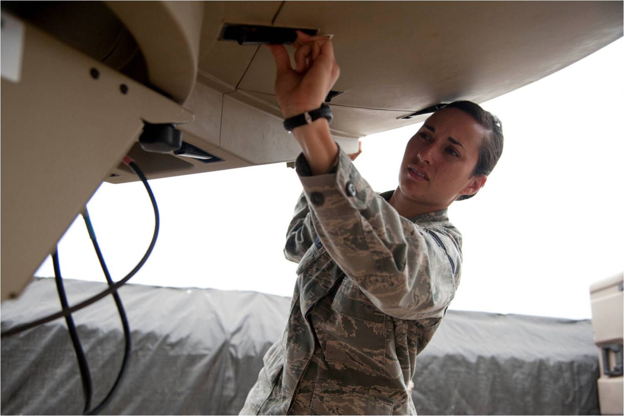 Staff Sgt. Jessica Hodges, a transmission systems technician with Combined Joint Task Force – Horn of Africa, maintains an access point satellite terminal here April 19, 2012. Technicians work at forward operating bases in the Horn of Africa to provide U.S. troops a secure medium for communications in support of CJTF-HOA missions. (U.S. Air Force photo by Staff Sgt. Andrew Caya)