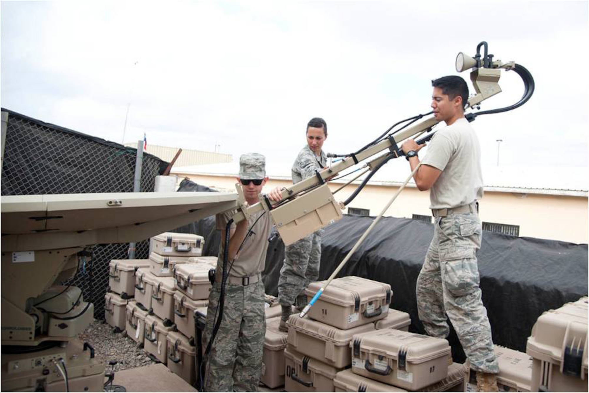 Tactical Networking technicians from the Combined Joint Task Force – Horn of Africa’s communications directorate assemble an access point satellite terminal here April 19, 2012. These terminals, operated by the TACNET section, provides U.S. troops a secure medium for communications in support of CJTF-HOA missions. (U.S. Air Force photo by Staff Sgt. Andrew Caya)