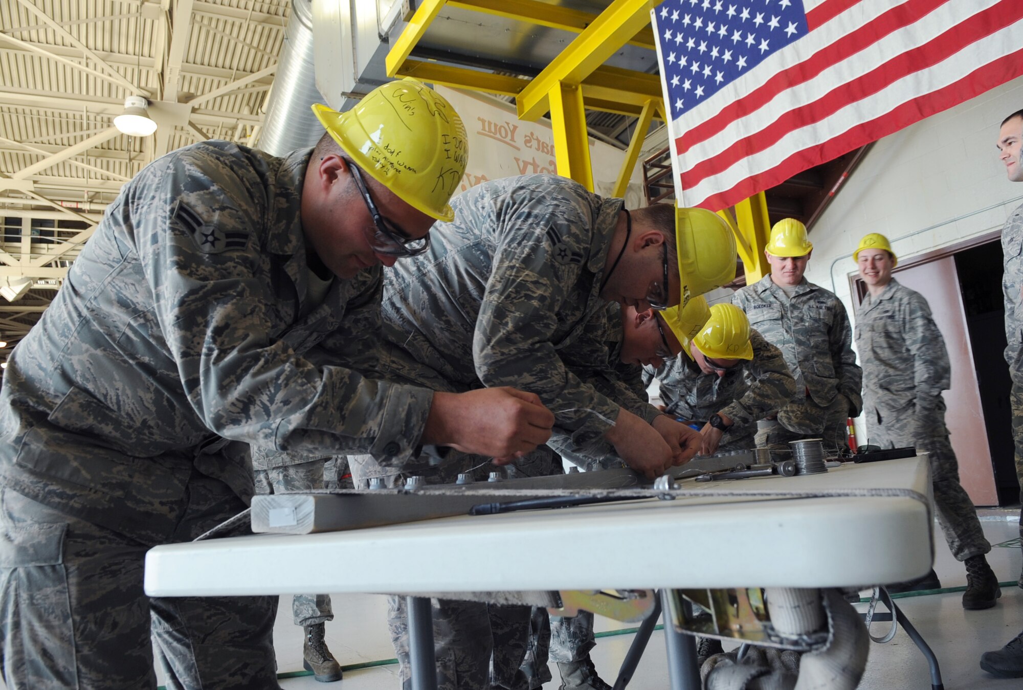 U.S. Air Force Airmen from the 354th Maintenance Squadron compete during the 354th Maintenance Group Olympics April 20, 2012, Eielson Air Force Base, Alaska. Airmen participated in the friendly competition to practice proper technique for applying safety wire for aircraft bolts. (U.S. Air Force photo/Airman 1st Class Lauren-Taylor Garcia)