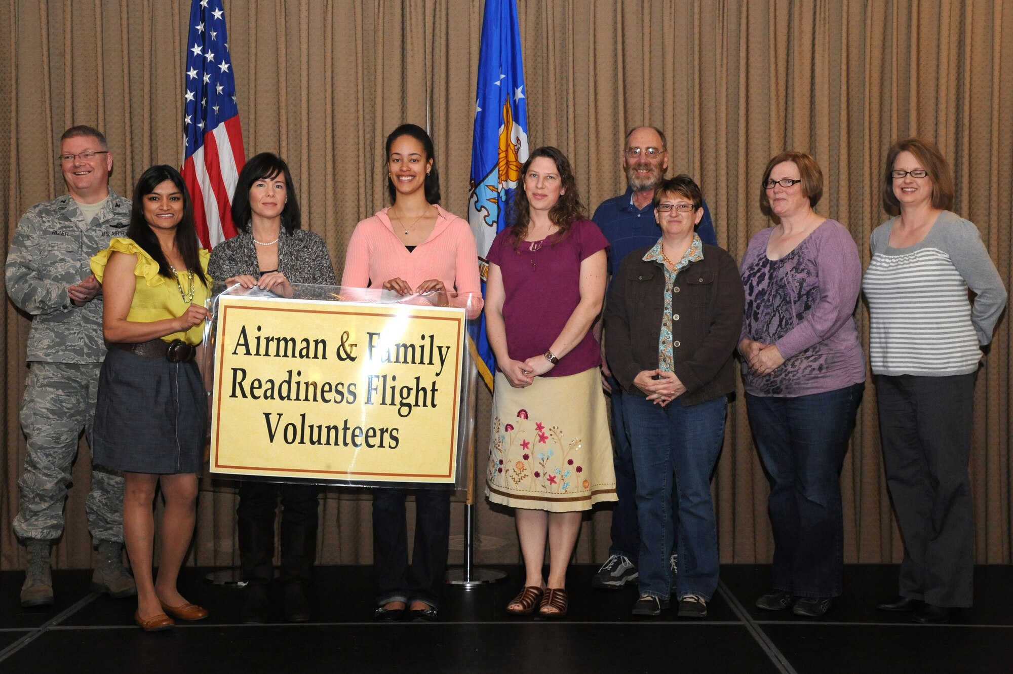 Col. Scott Rizer, 319th Air Base Wing vice commander, poses with employees and volunteers of the Airman and Family Readiness Center during the annual Volunteer Appreciation Luncheon on April 20, 2012, on Grand Forks Air Force Base, N.D.  (U.S. Air Force photo by Airman 1st Class Xavier Navarro)