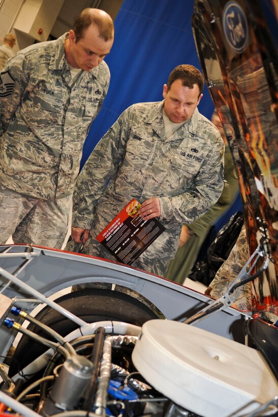 U.S. Air Force Master Sgt. Benjamin Tuck, Air Combat Command weapons safety, and Tech. Sgt. Ron Shay, ACC NCO in charge of flight safety, look under the hood of NASCAR driver Ricky Stenhouse Jr.’s, car, during a military appreciation barbecue on Langley Air Force Base, Va., April 26, 2012. During the lunch, hosted by the 633rd Force Support Squadron, Service members were able to meet Stenhouse and have items autographed. (U.S. Air Force photo by Senior Airman Wesley Farnsworth/Released)