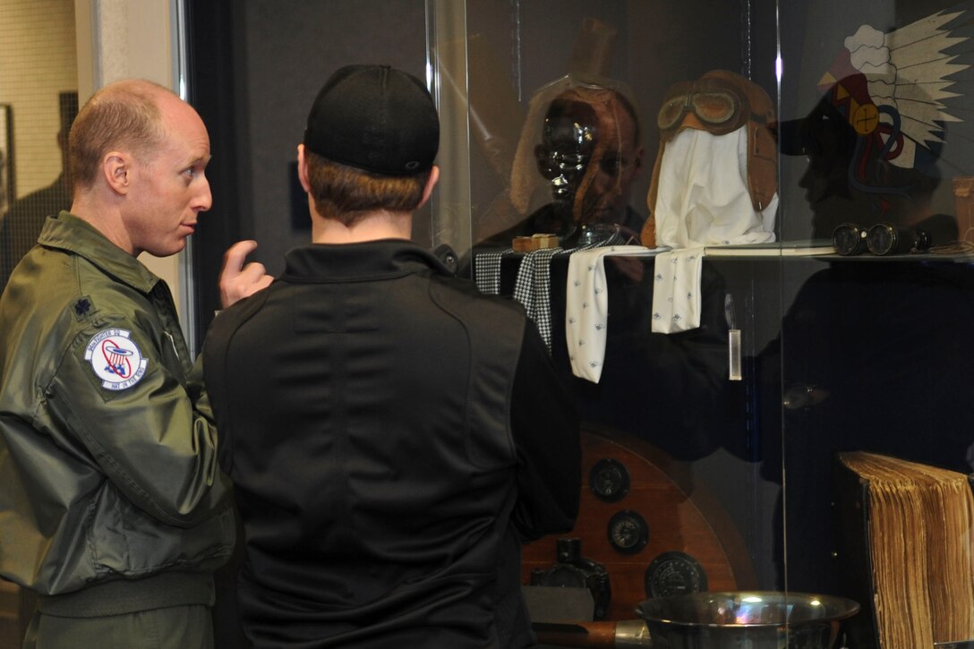 U.S. Air Force Lt. Col. Jason Hinds, 94th Fighter Squadron commander, explains the display of historical pilot gear to NASCAR driver Ricky Stenhouse, Jr., during a tour of Langley Air Force Base, Va., April 26, 2012. During the tour, Stenhouse visited several offices to visit troops, and participated in a military appreciation barbecue. (U.S. Air Force photo by Senior Airman Wesley Farnsworth/Released)