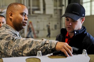 U.S. Air Force Staff Sgt. Richard Journagin, 1st Fighter Wing Munitions Flight crew chief, discusses the GBU-31 bomb with NASCAR driver Ricky Stenhouse, Jr., during a tour of Langley Air Force Base, Va., April 26, 2012. Stenhouse also participated in a military appreciation barbecue by signing autographs and talking with troops. (U.S. Air Force photo by Senior Airman Wesley Farnsworth/Released)