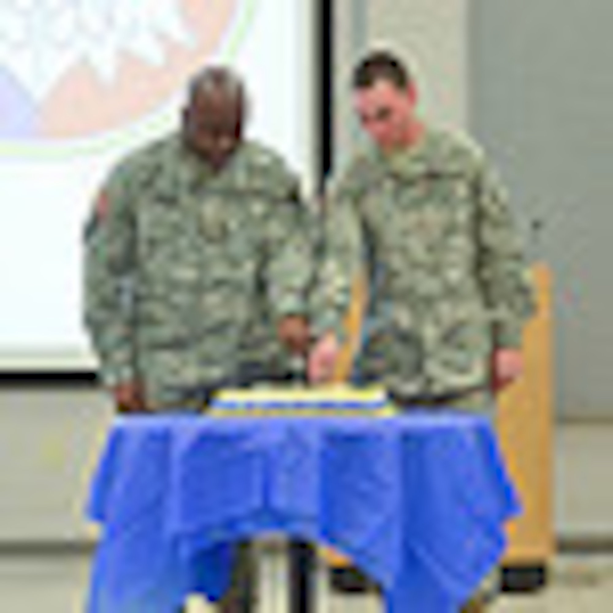 Representing the most senior offi cer present, Maj. Kevin D. Branch, Headquarter,
headquarters company, commander, 99th Regional Support Command, and
representing the most junior service member present, Private Kevin E. Graney,
99th RSC Yellow Ribbon Team, cut the cake commemorating the 104th birthday
of the U.S. Army Reserve at the Maj. John P. Pryor U.S. Army Reserve Center on
Joint Base McGuire-Dix-Lakehurst, N.J. April 23. (U.S. Army Photo/ Sgt. 1st Class
Alyn-Michael Macleod/Released)