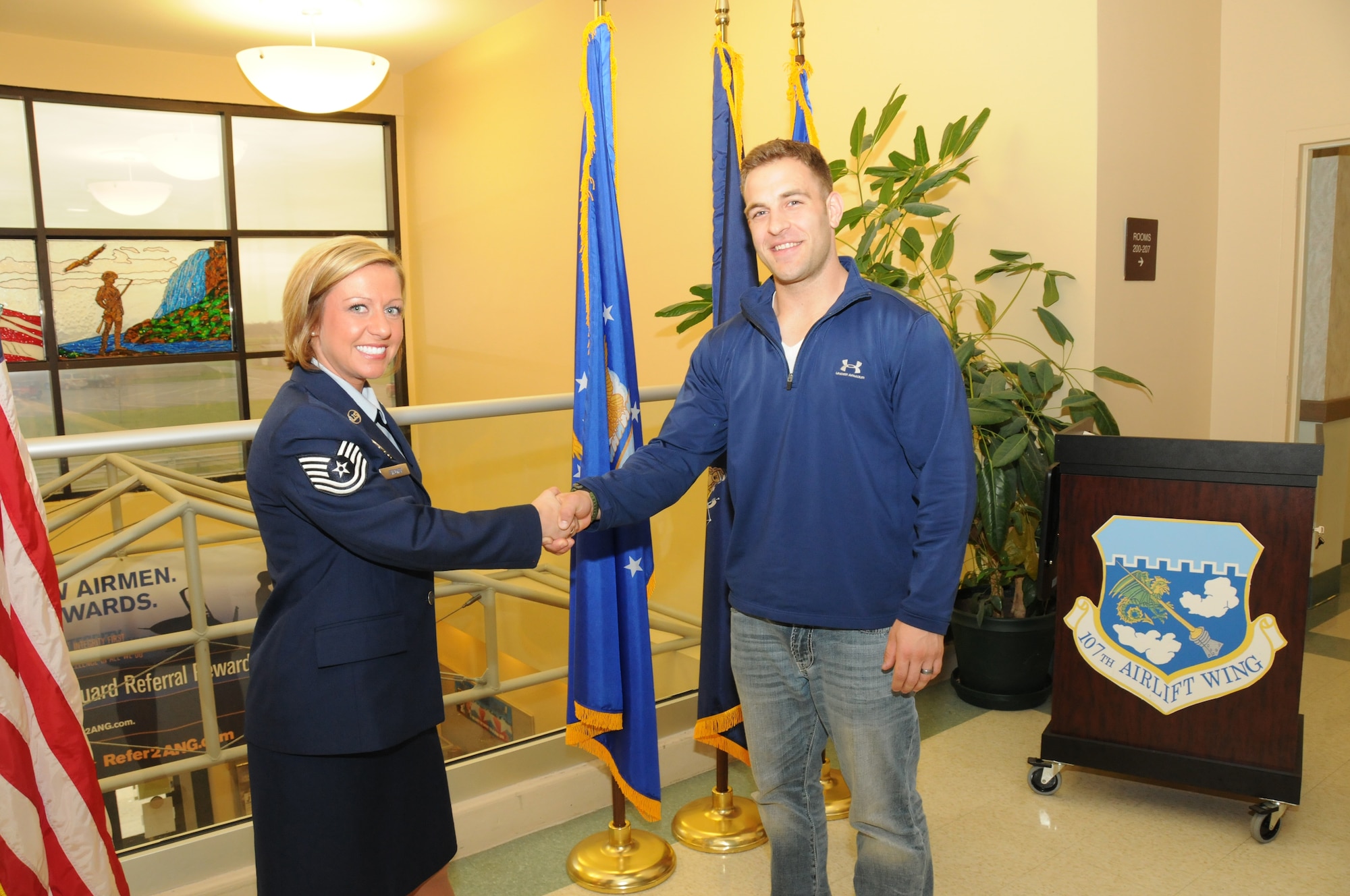 Tech. Sgt. Krystalore Stegner congratulates her first recruit, Jason Babirad. He is going into Fire Protection; his first step of his long career with the 107th Airlift Wing. April 26, 2012 (U.S. Air Force Photo by Senior Master Sgt. Ray Lloyd)