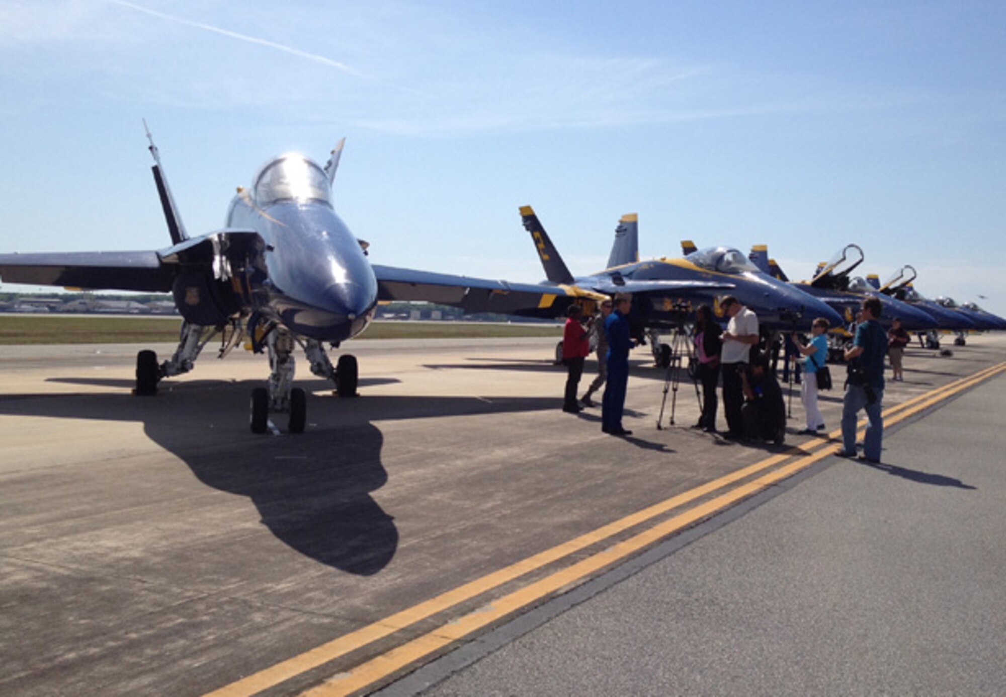 Members of local media outlets interview a pilot with the Blue Angels, the Navy's flight demonstration squadron.  The Blue Angels are at Robins in advance of the April 28-29 air show, where they will be performing.  