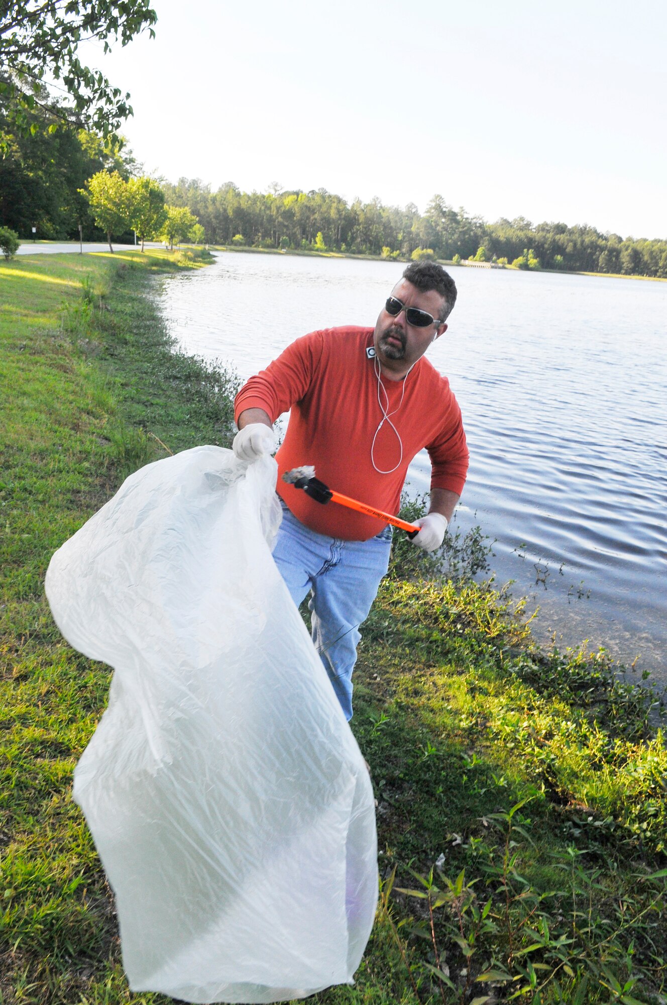 Griff Cox, 78th Civil Engineer Group, picks up trash and debris around Scout Lake Wednesday. The clean-up was part of the Robins Air Force Base Earth Day Celebration events. (U. S. Air Force photo by Sue Sapp)