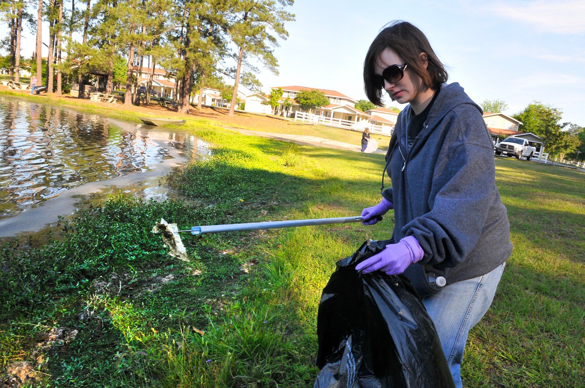 Laurel Cordell, 78th Civil Engineer Group, picks up trash and debris around Scout Lake Wednesday. The clean-up was part of the Robins Air Force Base Earth Day Celebration events. (U. S. Air Force photo by Sue Sapp)