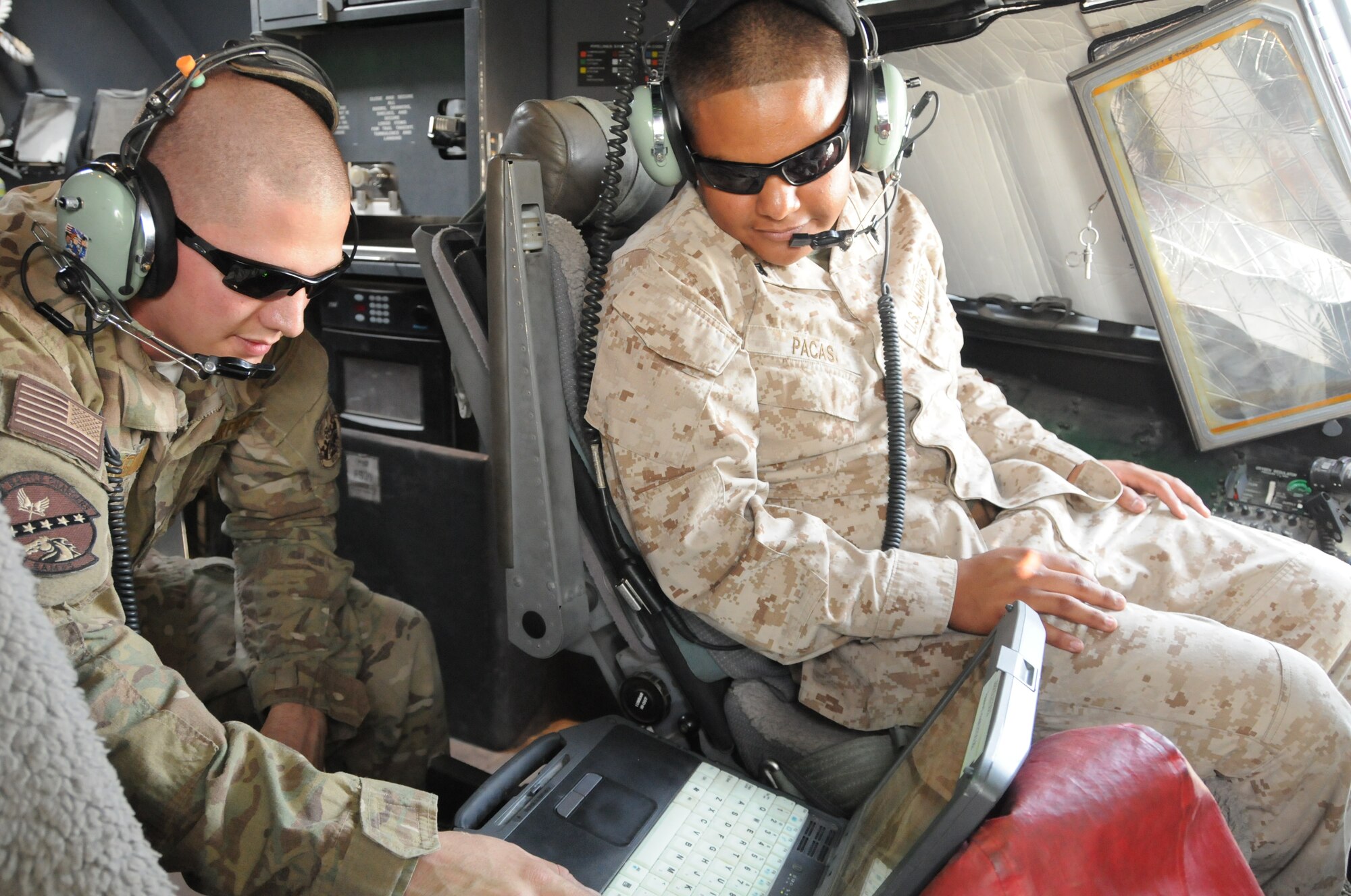 Senior Airman Jared Inbody (left), 451st Expeditionary Aircraft Maintenance Squadron guidance and control systems journeyman deployed from Little Rock Air Force Base, Ark., performs a C-130J air data systems operational check along with Corporal Christopher Pacas (right), Marine Aerial Refueler Transport Squadron 352 KC-130J electrician, here at Kandahar Airfield, Afghanistan, April 15, 2012. The two participated in a joint training exchange aimed at teaching different maintenance techniques as well as instilling inter-service communication and cooperation. (U.S. Air Force photo/Staff Sgt. Heather Skinkle)