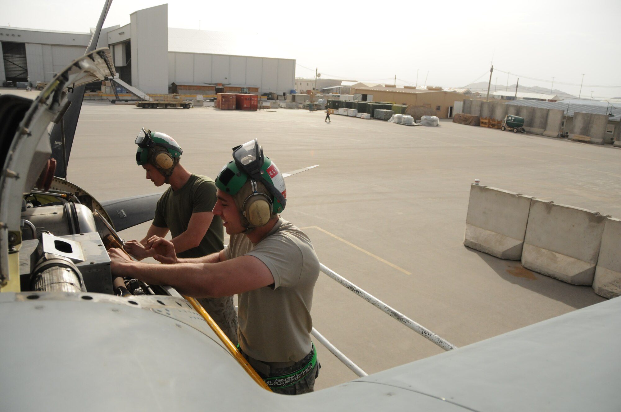 Staff Sgt. James Alesch II (right), 451st Expeditionary Aircraft Maintenance Squadron guidance and control systems journeyman deployed from Dyess Air Force Base, Texas, inspects a KC-130J engine along with Lance Corporal Coty Gatlin (left), Marine Aerial Refueler Transport Squadron 352 KC-130J electrician, here at Kandahar Airfield, Afghanistan, April 15, 2012. The two participated in a joint training exchange aimed at teaching different maintenance techniques as well as instilling inter-service communication and cooperation. (U.S. Air Force photo/Staff Sgt. Heather Skinkle)