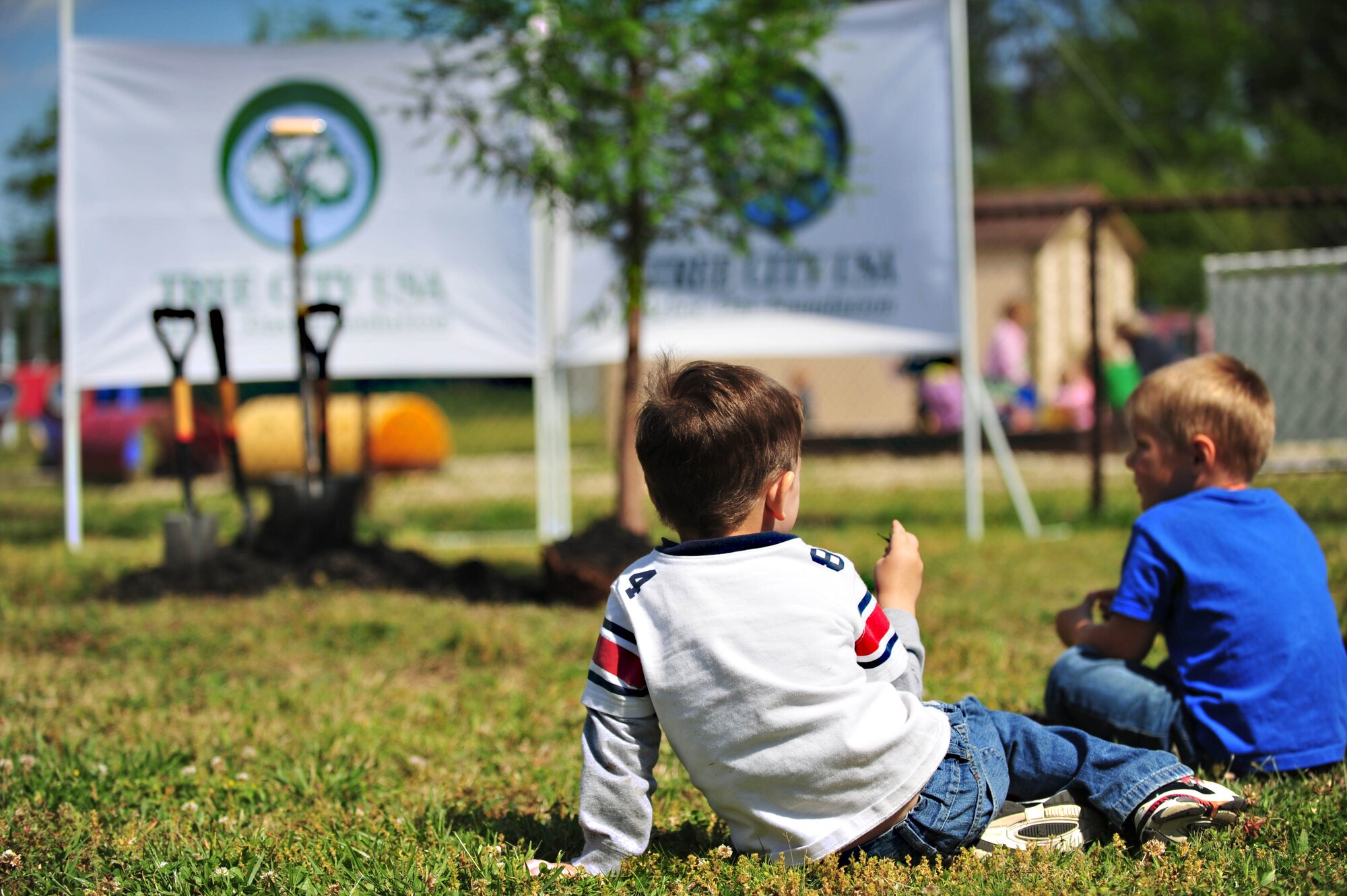 Gabriel Antor, left, and Nickolas Seeger, right, wait anxiously for a tree to be planted at the Langley Air Force Base, Va., child development center, April 25, 2012. The tree, which could live hundreds of years if properly cared for, was planted in honor of National Arbor Day. (U.S. Air Force photo by Senior Airman Jarad A. Denton/Released) 