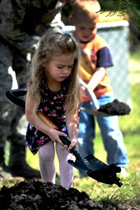 Jaymesan Weekley shovels dirt during a tree planting ceremony at the Langley Air Force Base, Va., child development center, April 25, 2012. Jaymesan was taught that if trees like the one she helped plant were properly cared for, they could live to be hundreds of years old. (U.S. Air Force photo by Senior Airman Jarad A. Denton/Released)