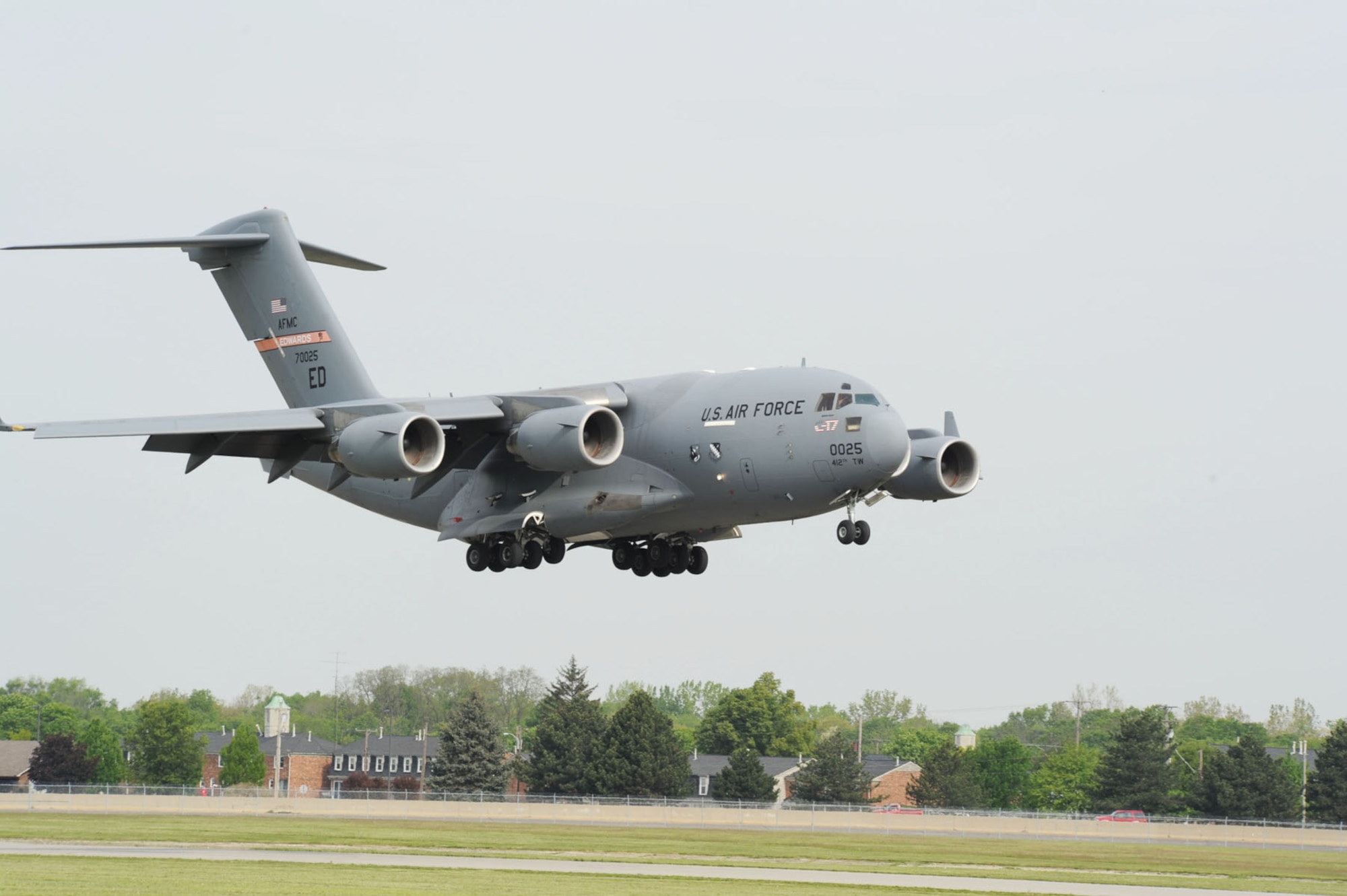 DAYTON, Ohio -- The U.S. Air Force's first C-17 (T-1) arrives at the National Museum of the U.S. Air Force after its final flight on April 25, 2012. This C-17 Globemaster III (S/N 87-0025) was essentially hand-built for the sole purpose of developmental test and evaluation, with an estimated life span of approximately five years. The aircraft was periodically rebuilt and refurbished over the years and its lifespan grew from five to 21 years. (U.S. Air Force photo by Jeff Fisher)