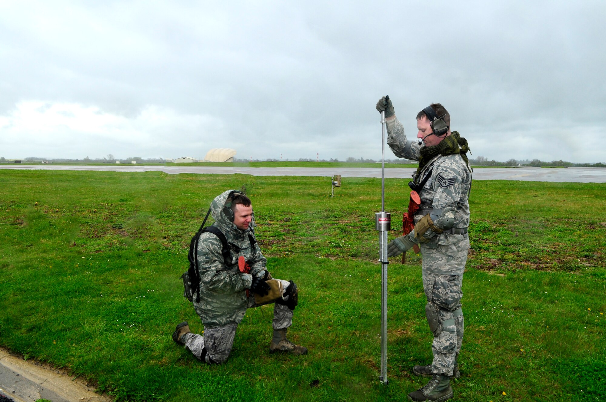 Staff Sgt. Jesse Stokes, 435th Security Forces Squadron civil engineer, tests the strength of the soil using a dynamic cone penetrometer, while Tech. Sgt. Stanley MacDonald, 435th Contingency Response Group air traffic controller, records the number of blows per inch during an airfield assessment at RAF Fairford, England, April 23, 2012. Members of the 435 CRG airfield assessment team assessed the airfield for the arrival of follow on 86th Airlift Wing forces.