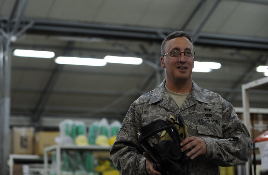 Staff Sgt. Casey Jones, 39th Civil Engineer Squadron emergency management logistics specialist, explains how to properly don a gas mask April 25, 2012, at Incirlik Air Base, Turkey. Emergency management is responsible for ensuring base preparedness in the event of a natural disaster, terrorist attack and hazardous material mishap. (U.S. Air Force photo by Senior Airman Jarvie Z. Wallace/Released)