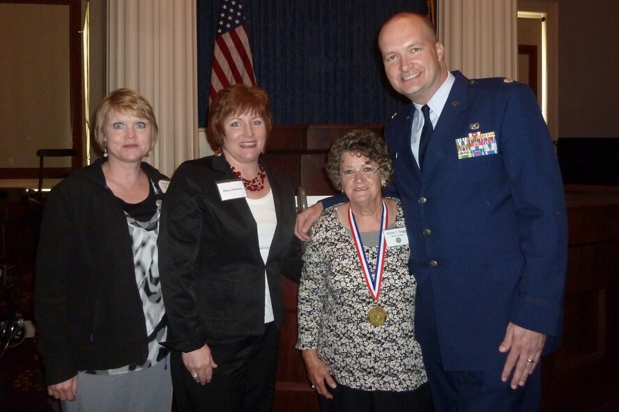 Ms. Nettie Twiggs poses with co-worker U.S. Air Force Lt. Col. Robert Preston and volunteers from Cherry Hill, N.C., Penny Withrow and Tonya Rollinds, at a Governor’s Medallion Ceremony in Raleigh, N.C., April, 19, 2012. Twiggs received a medallion and certificate of appreciation from Gov. Beverly Purdue during a ceremony that honored the top volunteers in North Carolina. Twiggs and Preston work in the 4th Fighter Wing legal office. (Courtesy photo)